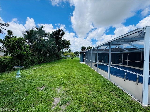 view of yard with glass enclosure