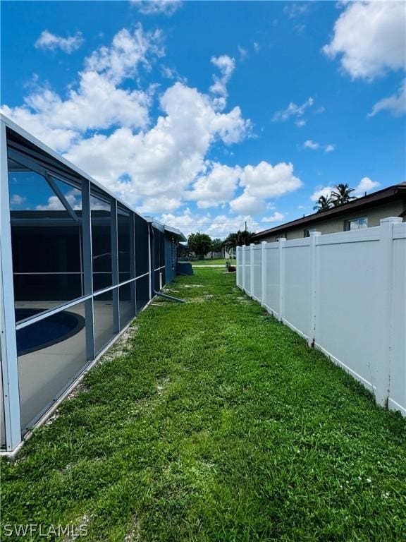 view of yard featuring glass enclosure