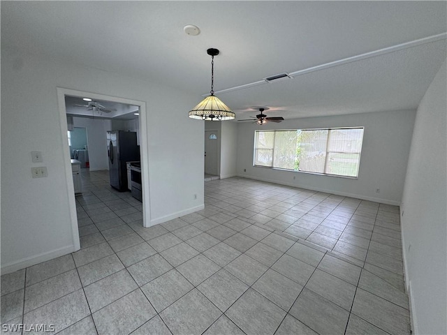 empty room featuring light tile patterned floors and ceiling fan