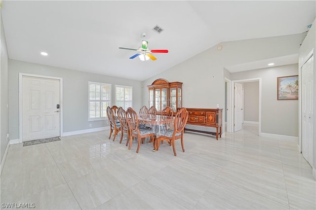 dining area with vaulted ceiling, ceiling fan, and light tile patterned flooring