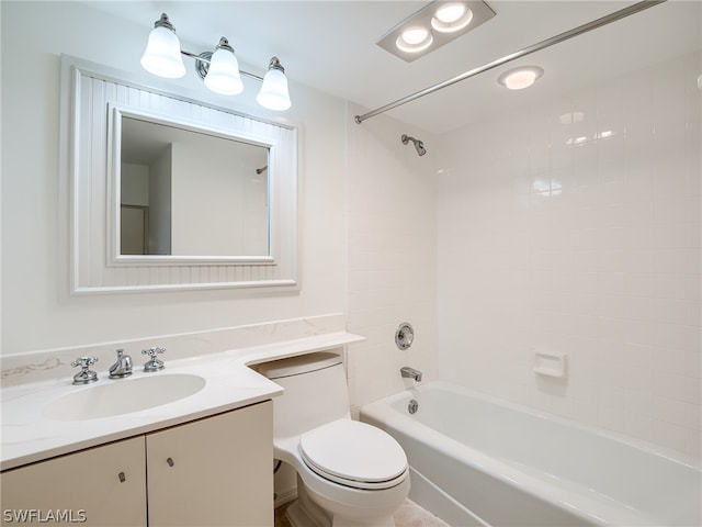 full bathroom with toilet, vanity, and tiled shower / bath