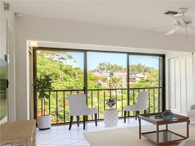 sunroom featuring ceiling fan