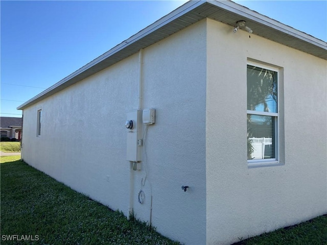 view of side of home featuring a lawn