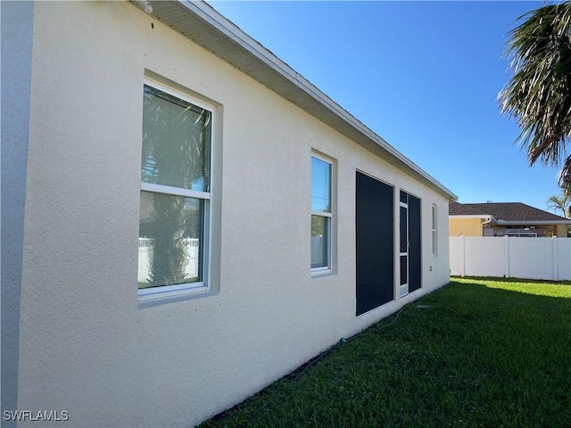 view of property exterior with a yard