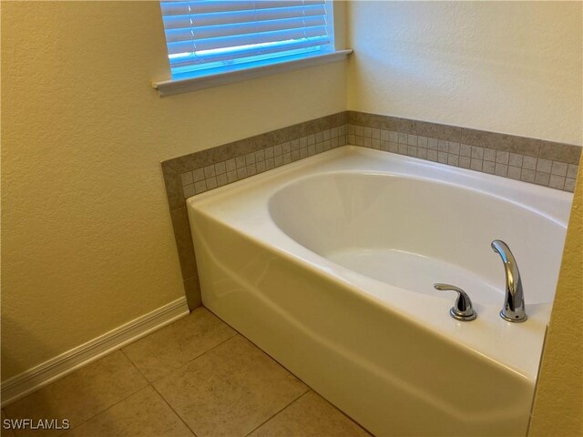 bathroom featuring tile patterned floors and a tub