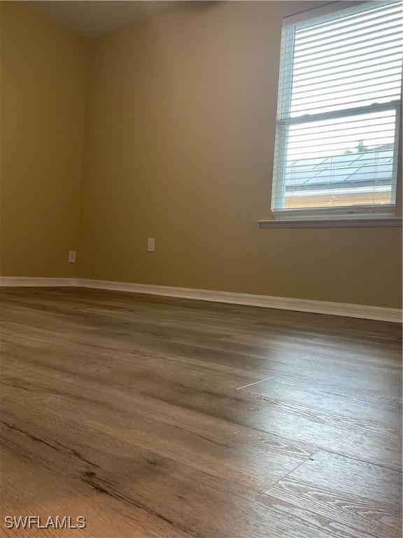 unfurnished room featuring hardwood / wood-style floors