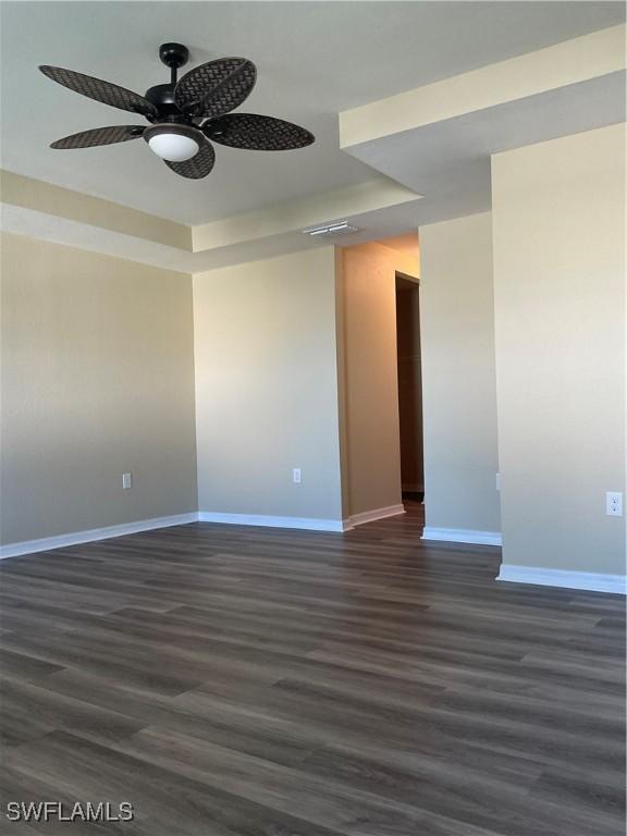 unfurnished room featuring dark hardwood / wood-style floors and ceiling fan