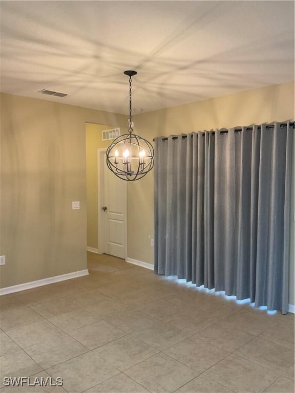 empty room with an inviting chandelier