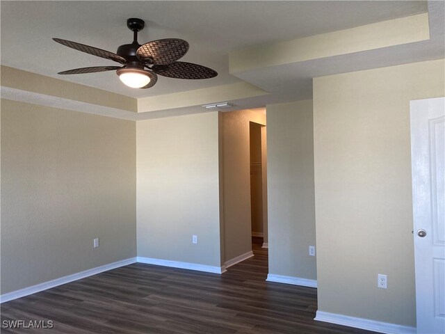 unfurnished room featuring ceiling fan and dark hardwood / wood-style flooring