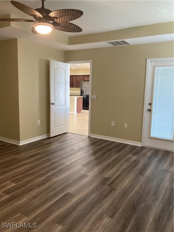 spare room with ceiling fan and dark hardwood / wood-style flooring