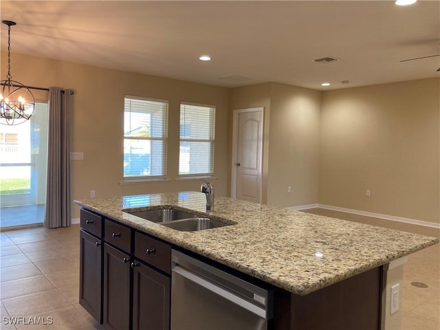 kitchen featuring light stone counters, sink, pendant lighting, and dishwasher