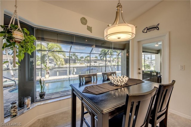 tiled dining space featuring a water view