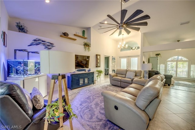 living room with ceiling fan with notable chandelier, high vaulted ceiling, light tile patterned flooring, and french doors