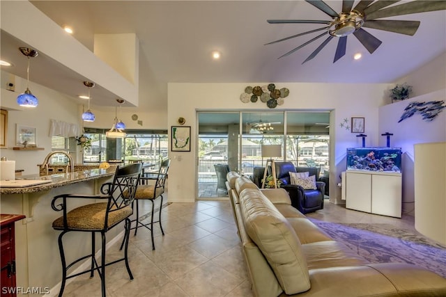 living room with ceiling fan with notable chandelier and light tile patterned floors