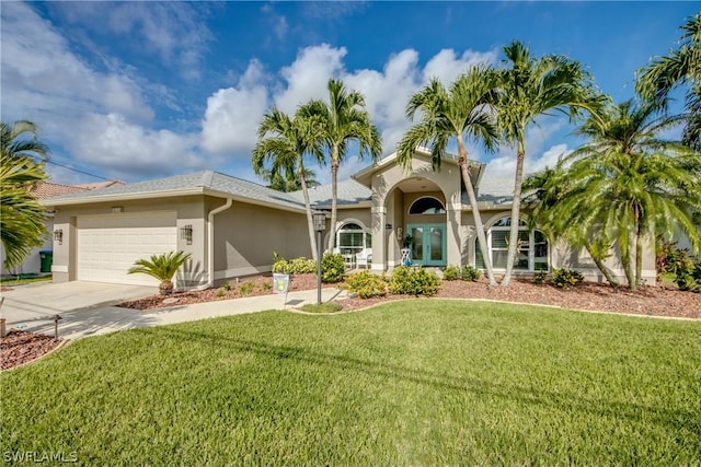 mediterranean / spanish-style home featuring a garage and a front lawn