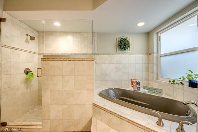 bathroom featuring independent shower and bath