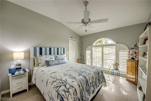 carpeted bedroom with ceiling fan, vaulted ceiling, and a closet