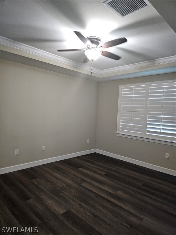 spare room featuring dark hardwood / wood-style flooring, ceiling fan, and ornamental molding