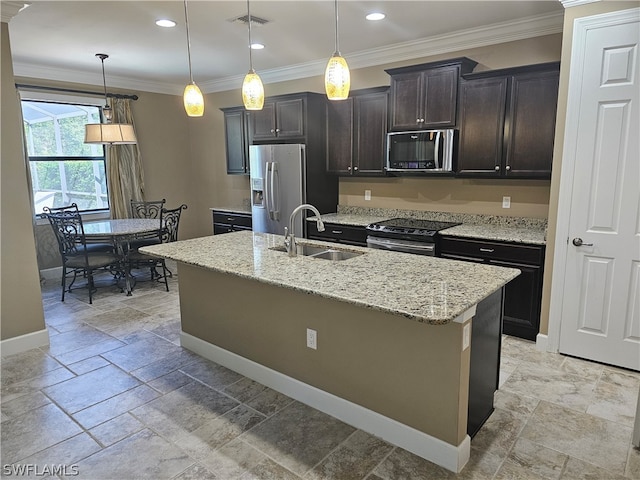 kitchen with hanging light fixtures, sink, an island with sink, and stainless steel appliances