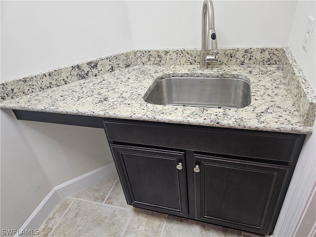 interior details with light stone countertops and sink