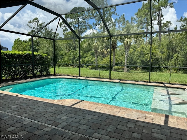 view of pool featuring a lanai and a patio