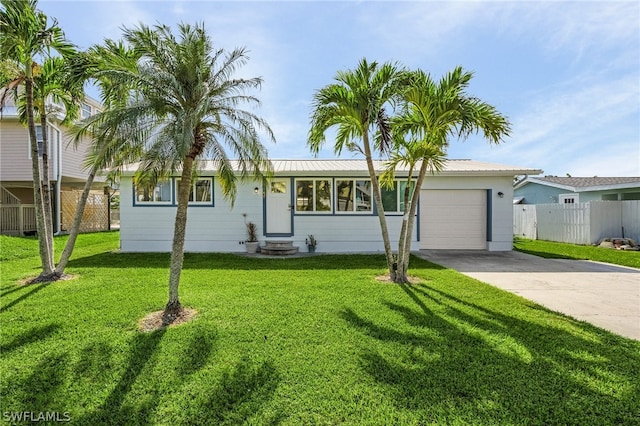 ranch-style house featuring a garage and a front yard