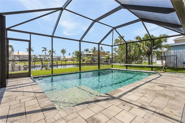 view of swimming pool featuring a water view, a lanai, and a patio