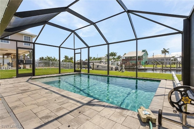 view of swimming pool with a water view, a patio, glass enclosure, and a lawn