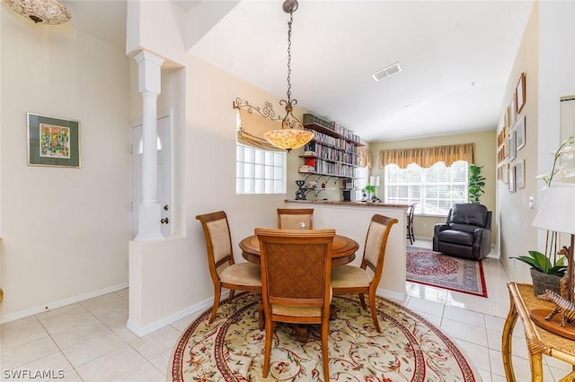 tiled dining space featuring ornate columns