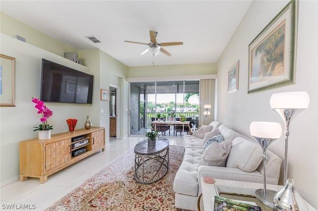 living room with ceiling fan and light tile patterned flooring