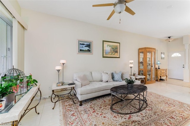 tiled living room featuring ceiling fan