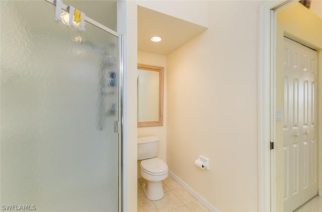 bathroom featuring an enclosed shower, toilet, and tile patterned flooring