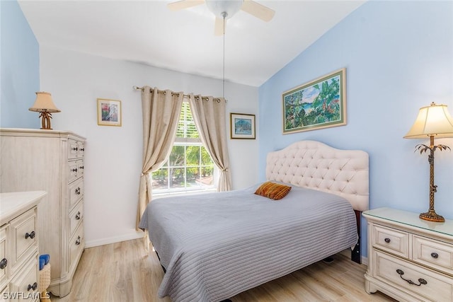 bedroom featuring ceiling fan, vaulted ceiling, and light wood-type flooring