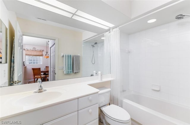 full bathroom featuring toilet, vanity, and shower / bathtub combination with curtain