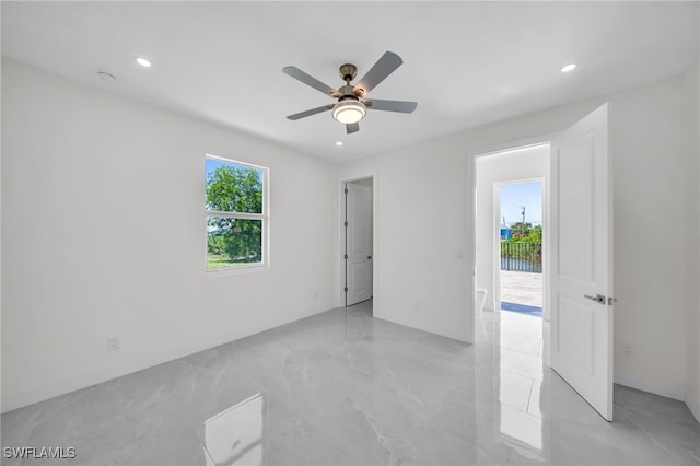 unfurnished room featuring ceiling fan and light tile patterned flooring