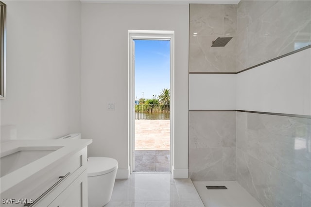 bathroom with a wealth of natural light, vanity, tile patterned floors, and toilet