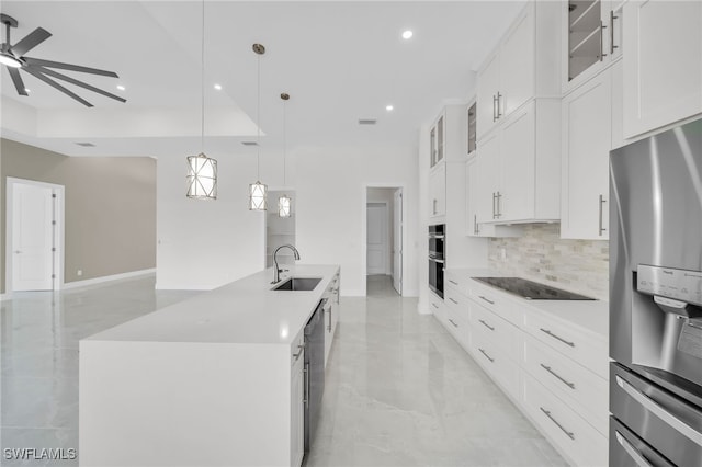 kitchen with stainless steel appliances, decorative backsplash, white cabinets, light tile patterned floors, and ceiling fan