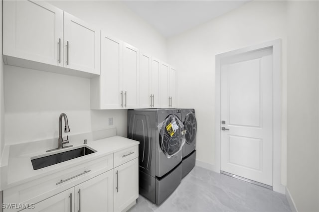 washroom featuring sink, cabinets, separate washer and dryer, and light tile patterned floors