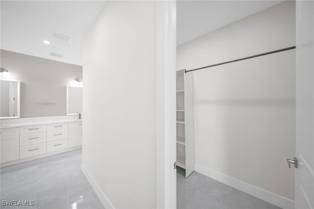 interior space featuring tile patterned floors and double sink vanity