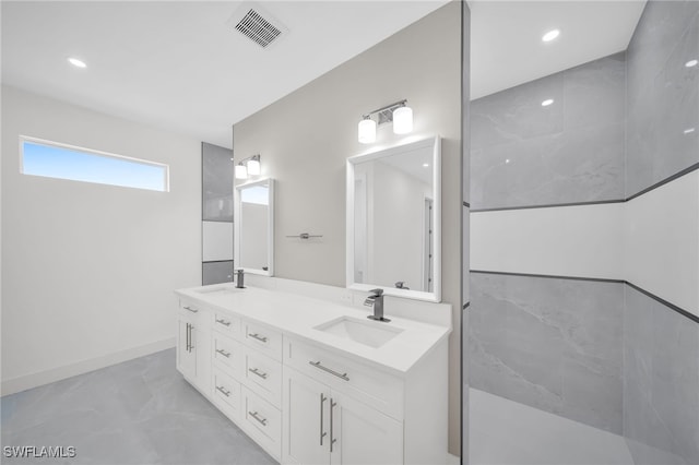 bathroom featuring tile patterned flooring and dual bowl vanity