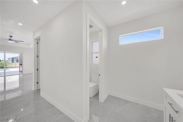 bathroom featuring toilet, tile patterned floors, plenty of natural light, and vanity