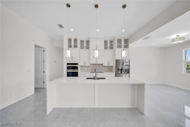 kitchen with sink, white cabinetry, light tile patterned floors, and stainless steel appliances