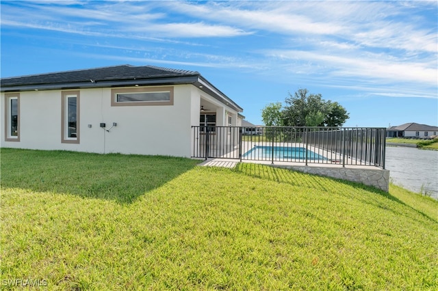 view of yard with a fenced in pool