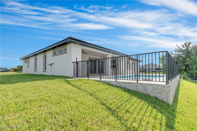 rear view of house with a yard