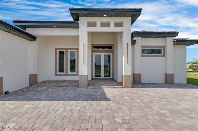 property entrance with french doors and a patio area