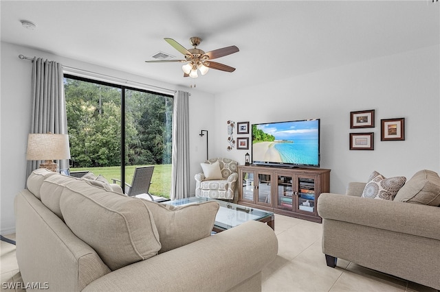 tiled living room featuring ceiling fan