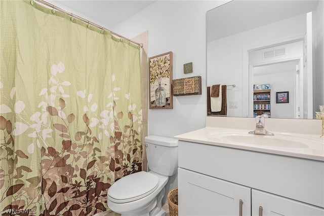 bathroom featuring toilet and vanity