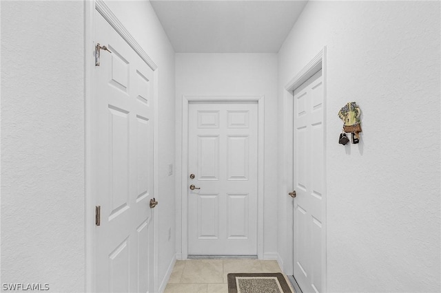 hall with light tile patterned flooring