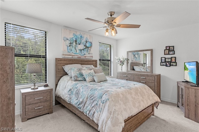 bedroom with ceiling fan and light colored carpet