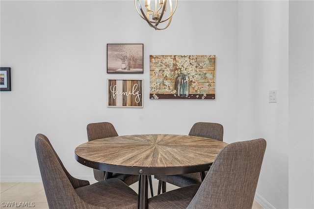 tiled dining room with an inviting chandelier